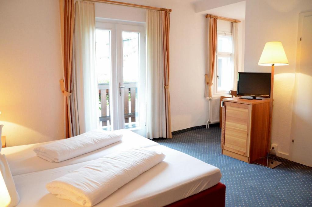 Postel nebo postele na pokoji v ubytování Seehotel Schlick