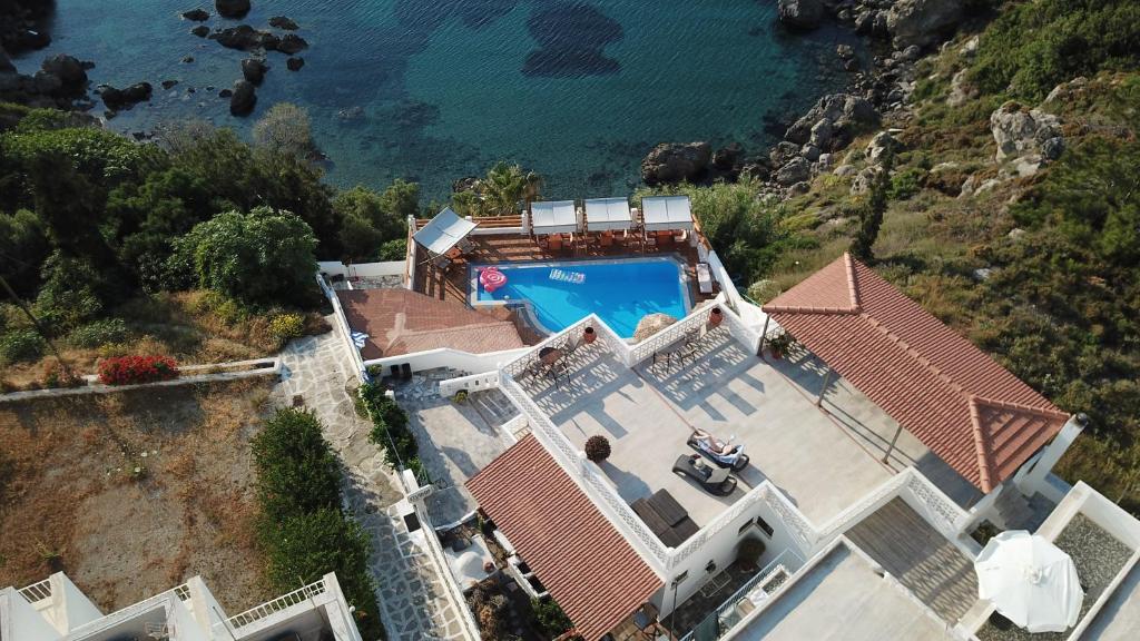 an aerial view of a house with a swimming pool at Fatolitis Studios in Masouri