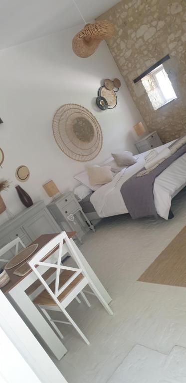 a bedroom with two beds and a stool in it at Chambre Lily in Parranquet