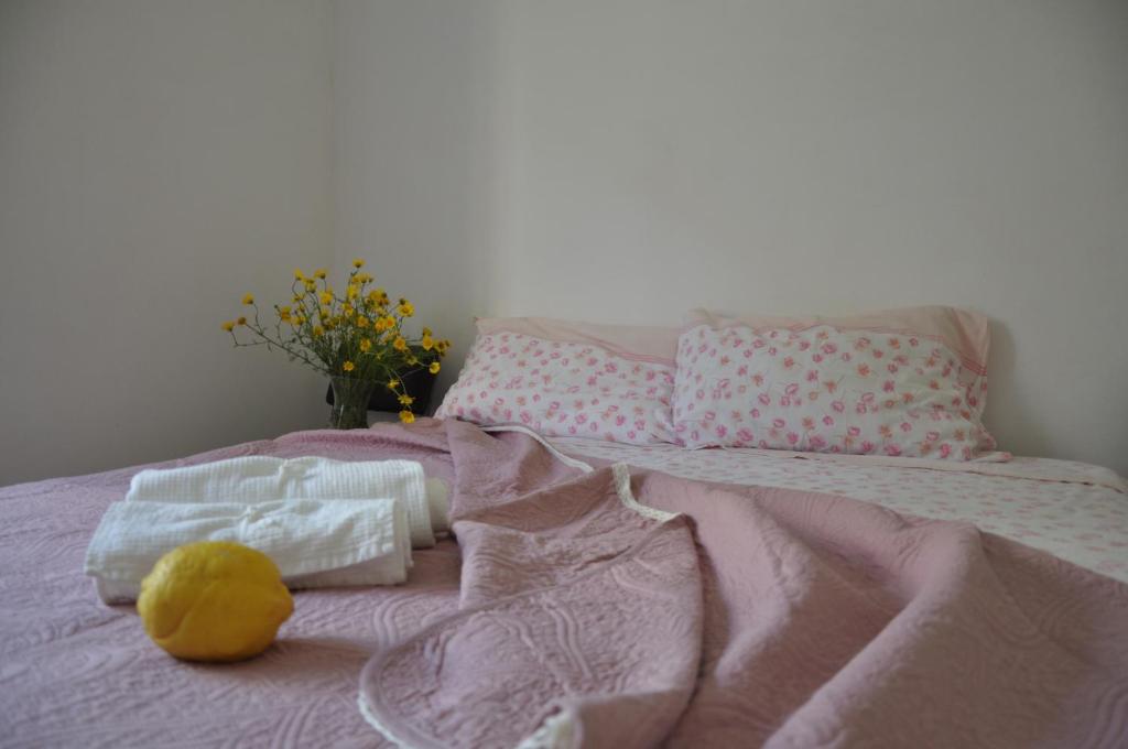 een roze bed met handdoeken en een knuffeldier erop bij B&B Fronte mare in Belmonte Calabro