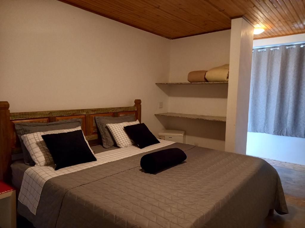 a bedroom with two beds with pillows on them at Pousada Serra Morena in Serra do Cipo