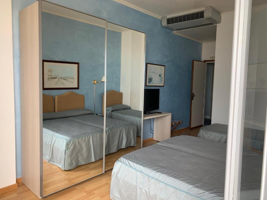Postel nebo postele na pokoji v ubytování Hotel Universo