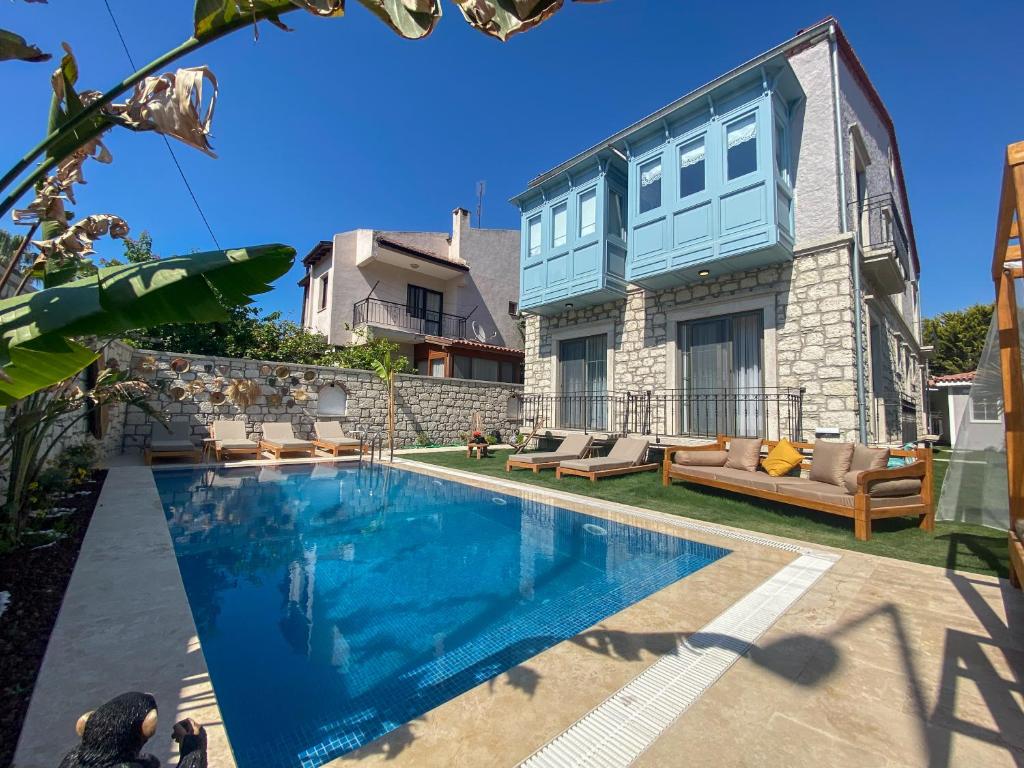 a swimming pool in front of a house at NO 35 Alaçatı in Alacati