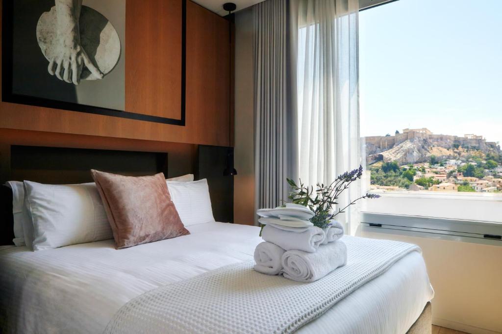 a hotel room with a bed and a window at Urban Frame Hotel in Athens