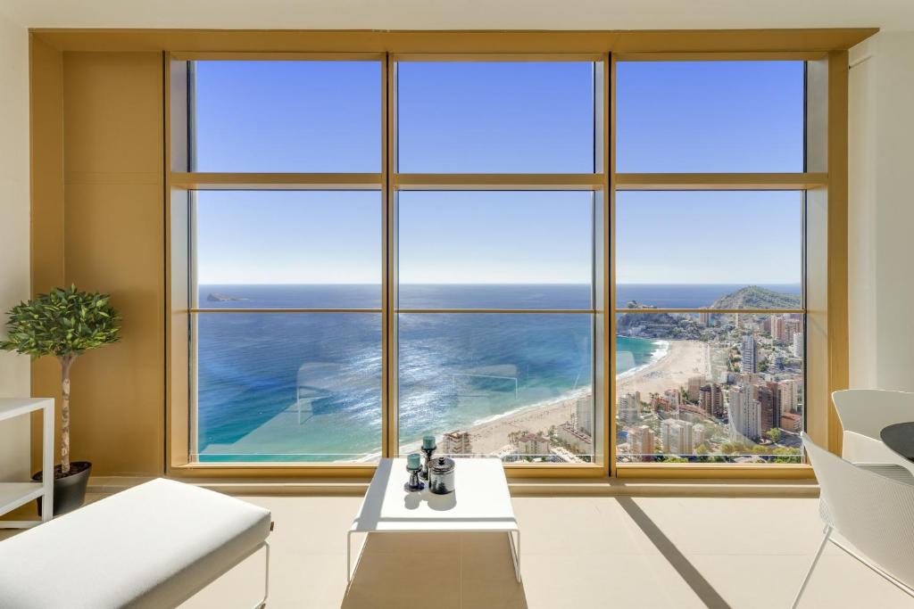 a room with a large window with a view of the ocean at INTEMPO SKY RESORT by Costa Activa Rentals in Benidorm
