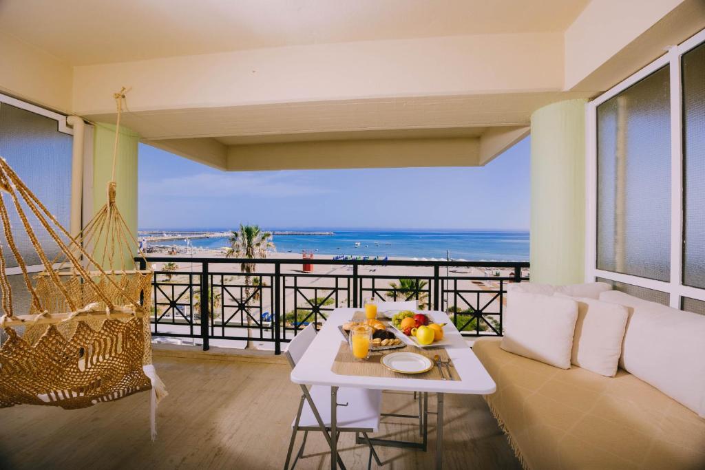 a living room with a hammock and a view of the ocean at Breathless Sea Studio in Rethymno Town