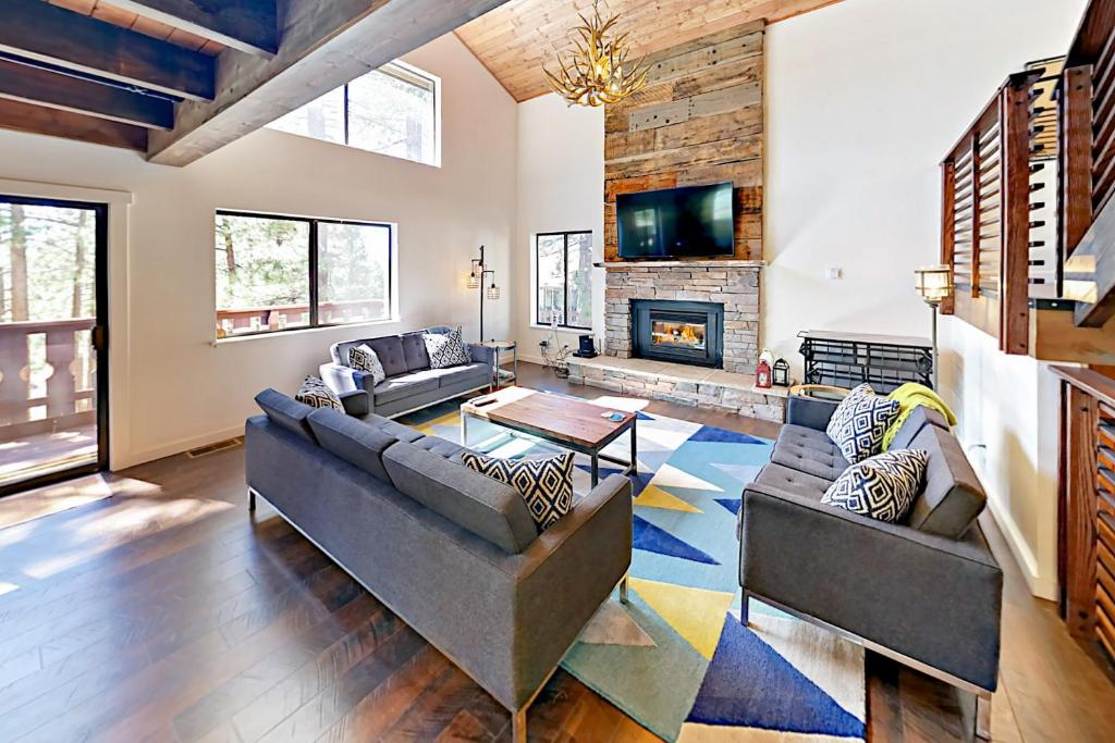 a living room with two couches and a fireplace at Tahoe Tyrol Chalet in South Lake Tahoe