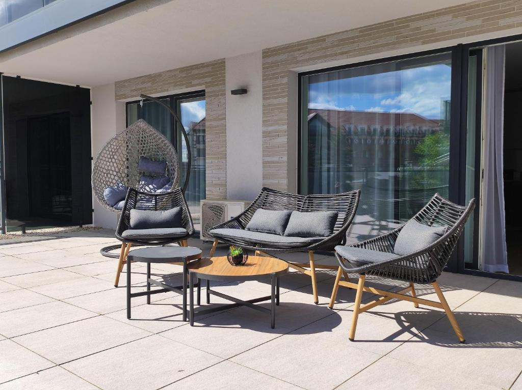 a group of chairs and a table on a patio at Lake Chill - MAZURIA APARTAMENTY in Ostróda