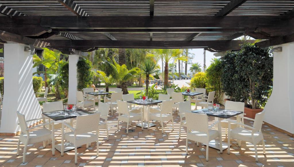 a set of tables and chairs on a patio at H10 Estepona Palace in Estepona