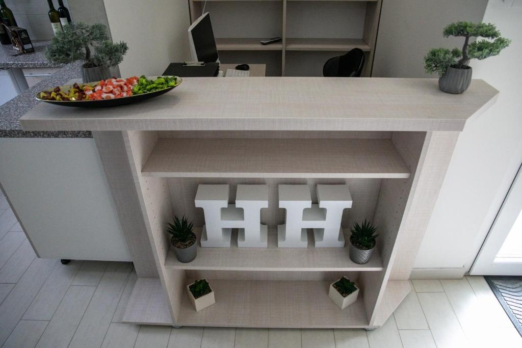 a kitchen island with a bowl of fruit on it at Happy Hill Rooms in Banja Luka