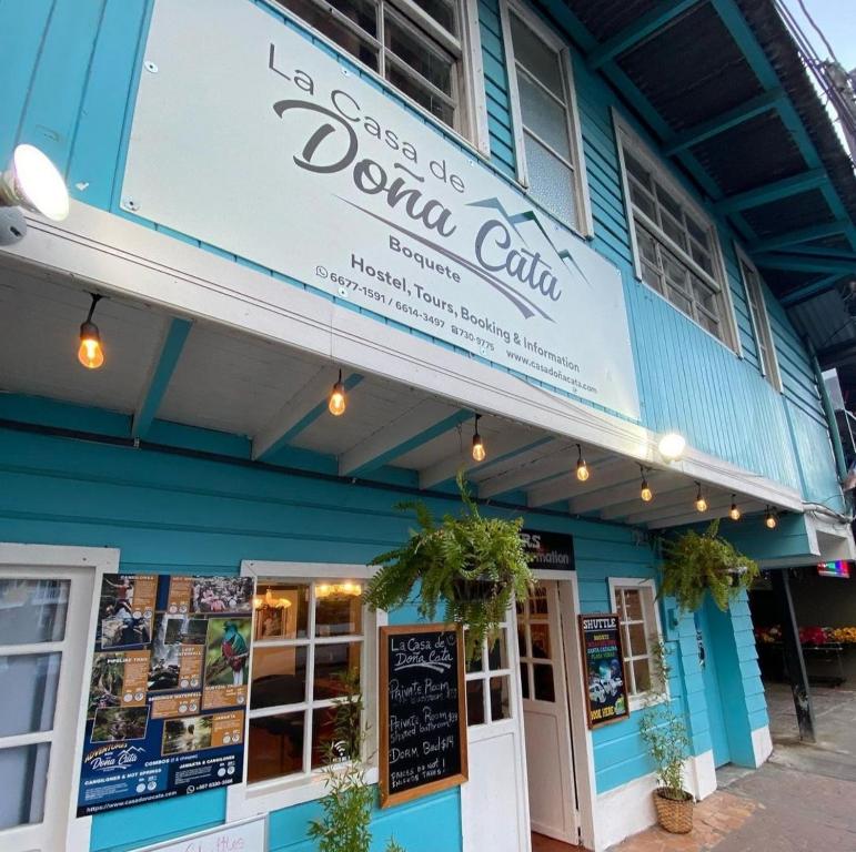 a blue building with a sign that reads normal cafe at La Casa de Doña Cata in Bajo Boquete