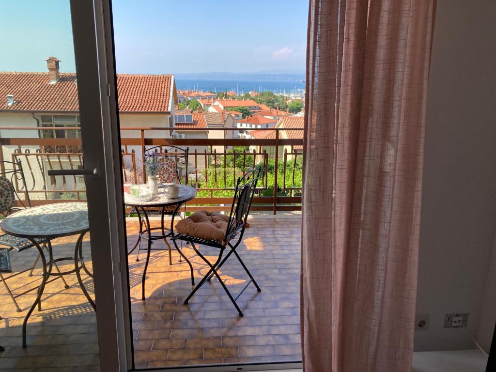 a view of a balcony with a table and chairs at Bellevue in Izola