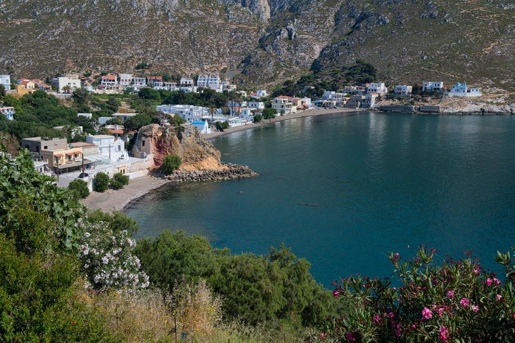 a view of a body of water with a town at Calliope Paradise Balcony in Panormos Kalymnos