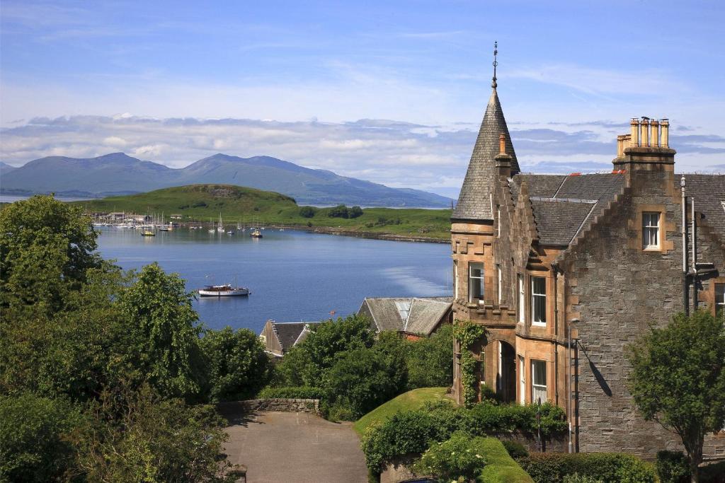 an old stone house with a view of a lake at Greystones B&B in Oban