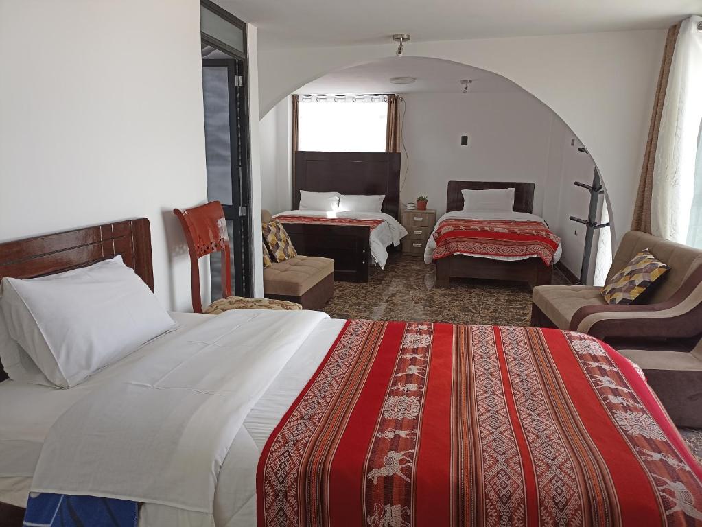 Rúm í herbergi á Hostal Killaly Inn Cusco
