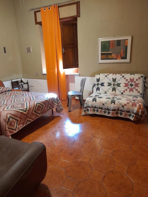 a living room with a bed and a couch at 3 vani 700 Mt mare e 3000 Mt da Capo D'Orlando in Naso