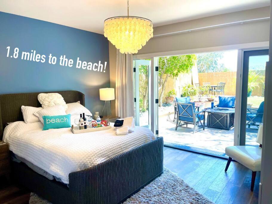 a bedroom with a bed with a sign with miles to the beach at Spacious, Luxury Ocean Master Suite 2 BD With Kitchenette in San Diego