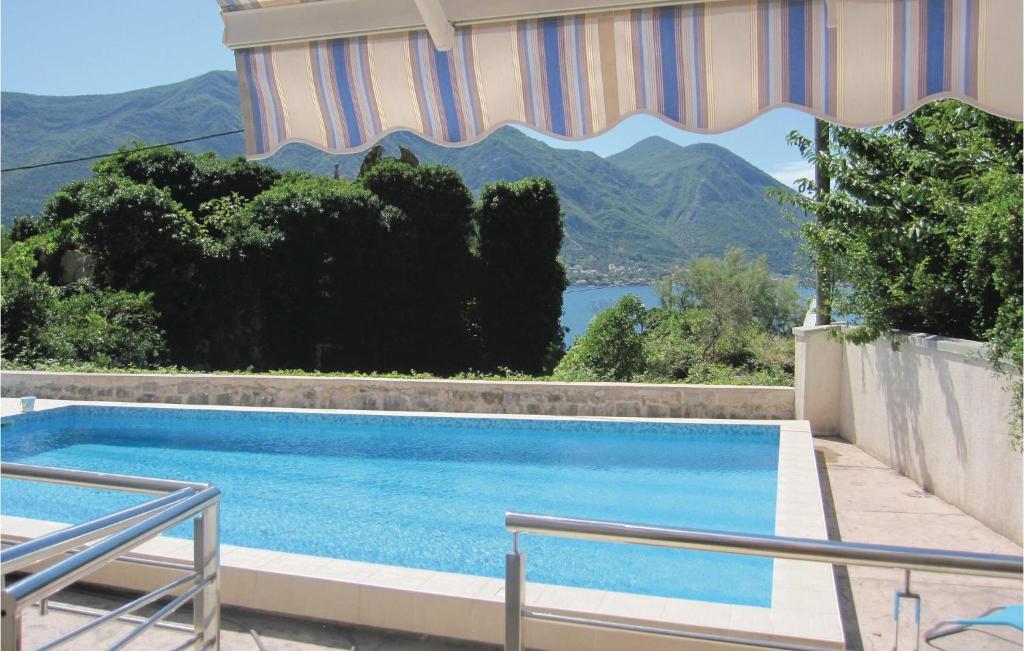a swimming pool with a view of a mountain at 1 Bedroom Nice Apartment In Kotor in Kotor