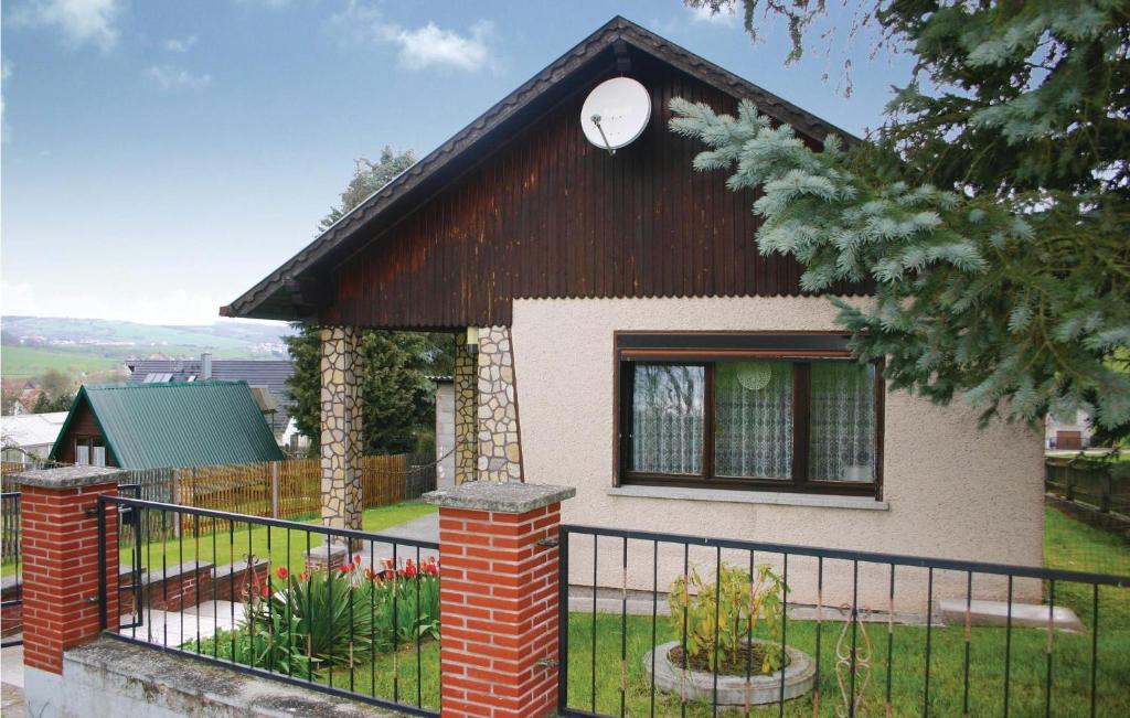 una pequeña casa con una valla negra delante de ella en 2 Bedroom Gorgeous Home In Fischbach, en Fischbach