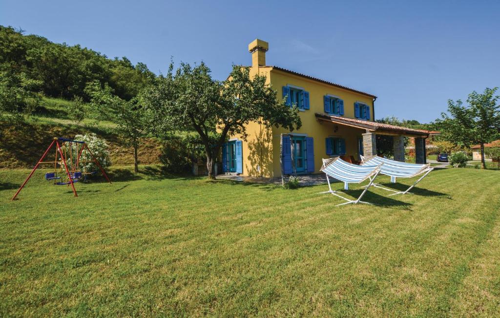 a house with two white chairs in the yard at Gorgeous Home In Koper With Wifi in Koper