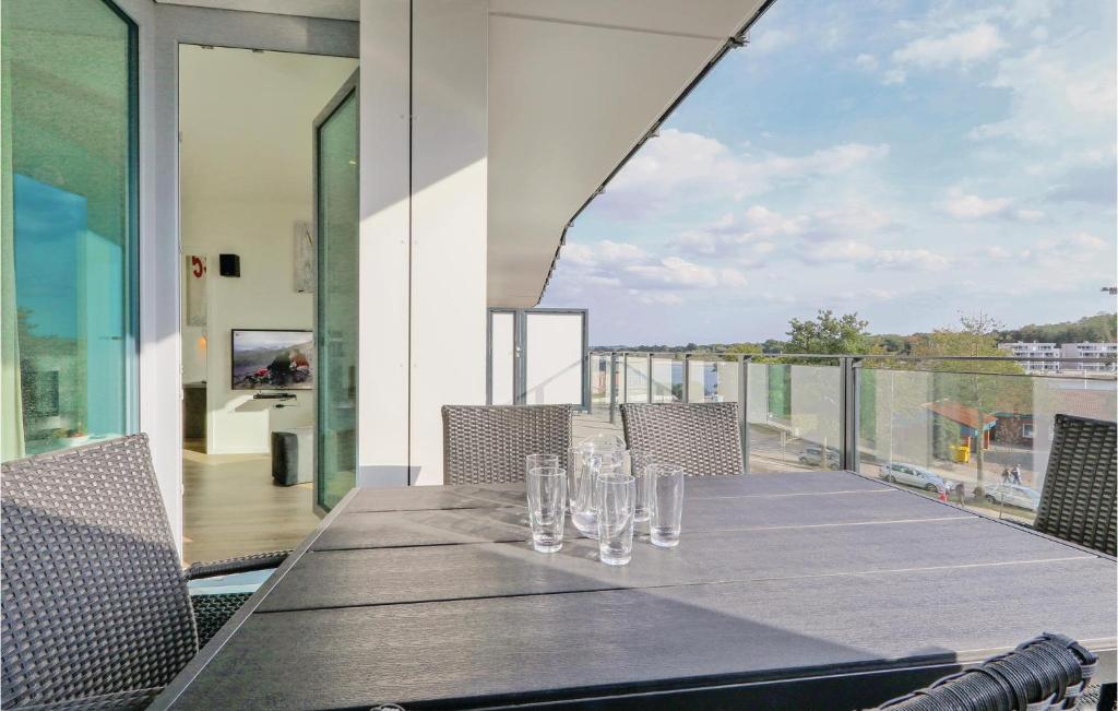 a table on a balcony with glasses on it at Highend Travemünde - Whg 112 in Travemünde