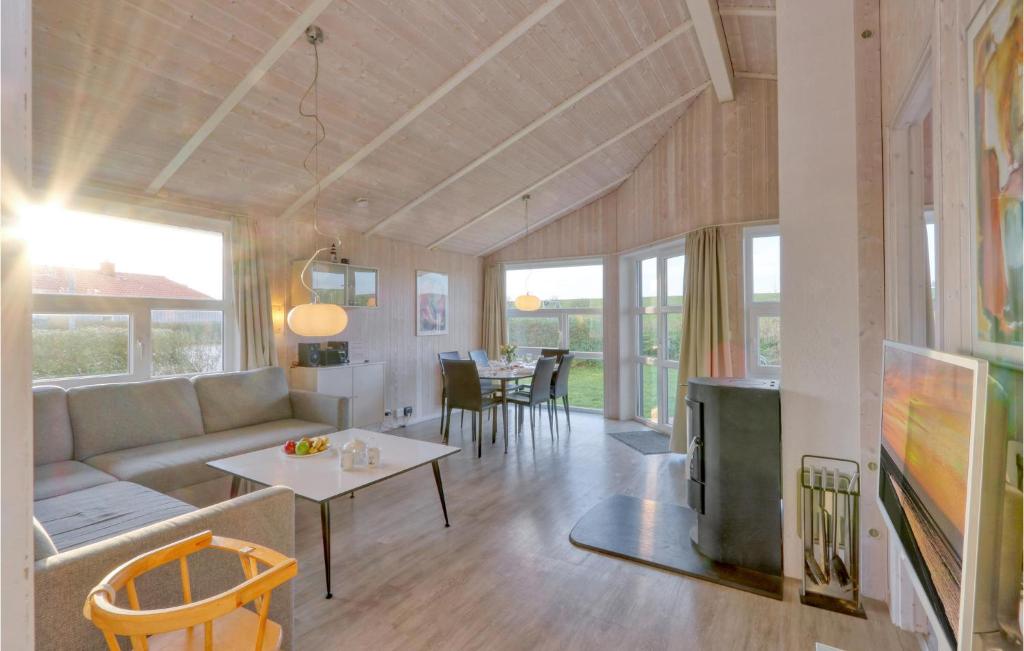 a living room with a couch and a table at Friedrichskoog-Strandpark 9 in Friedrichskoog
