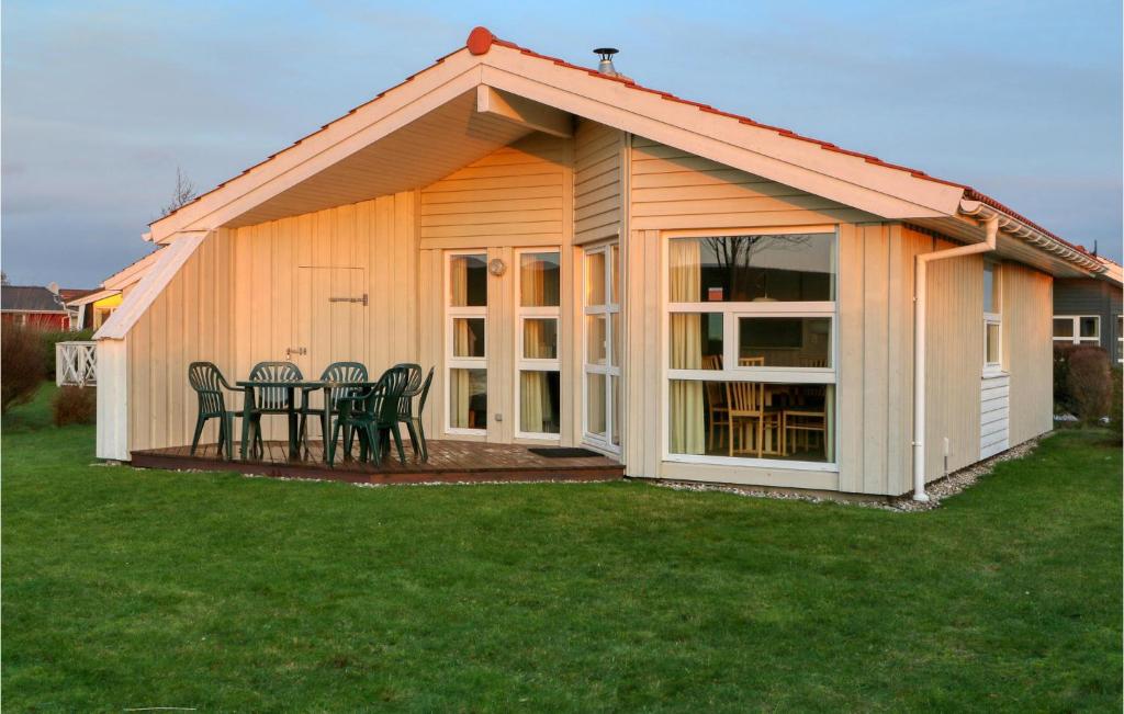 a house with a table and chairs in a yard at Friedrichskoog-Strandpark 12 in Friedrichskoog