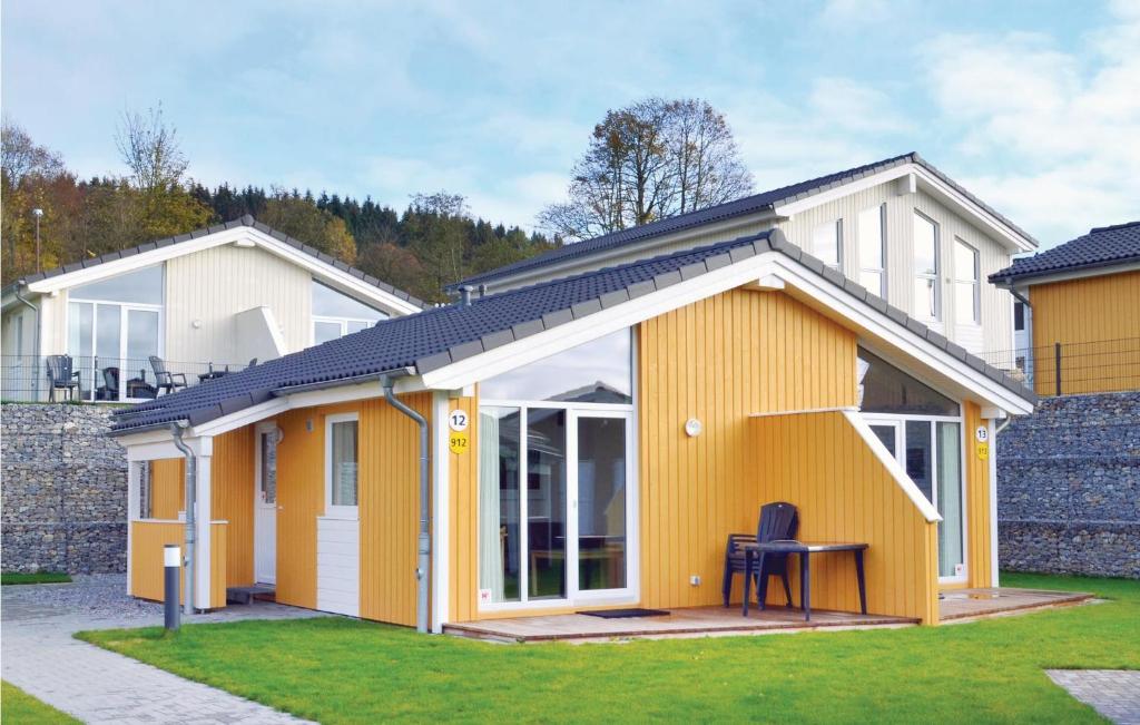 a yellow house with a table in a yard at St, Andreasberg, Haus 13 in Sankt Andreasberg