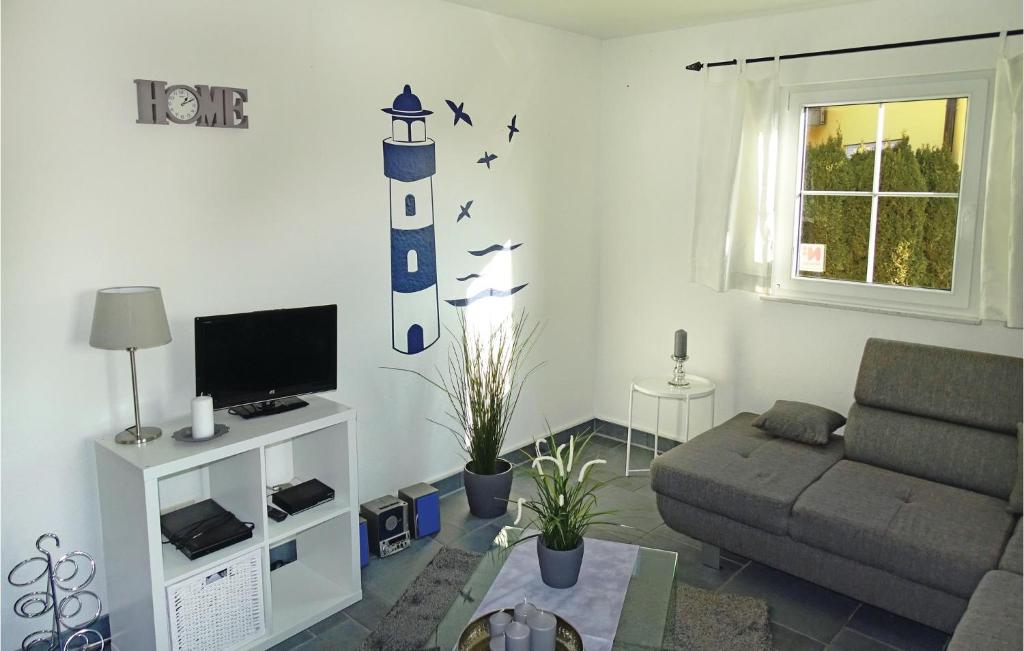 ein Wohnzimmer mit einem Sofa und einem TV in der Unterkunft Amazing Apartment In Boiensdorf With 2 Bedrooms in Boiensdorf