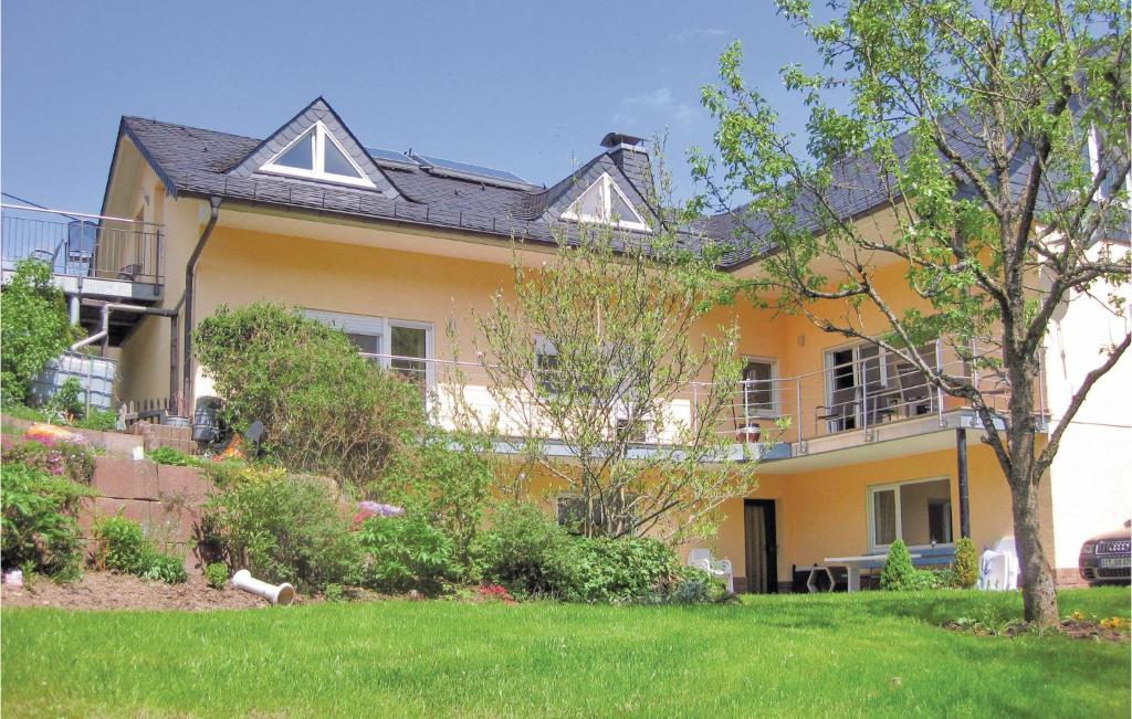 a large yellow house with a lawn in front of it at Nice Apartment In Zweifelscheid With Wifi in Zweifelscheid