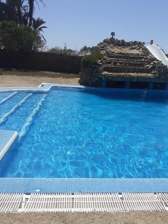 a large swimming pool with blue water at Atlantic Vacation villa in Dar Oulad Hajj Kassem