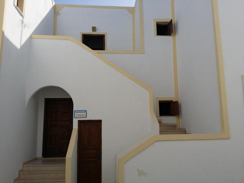 a stairway in a building with a door and stairs at Ocean View in Kamari