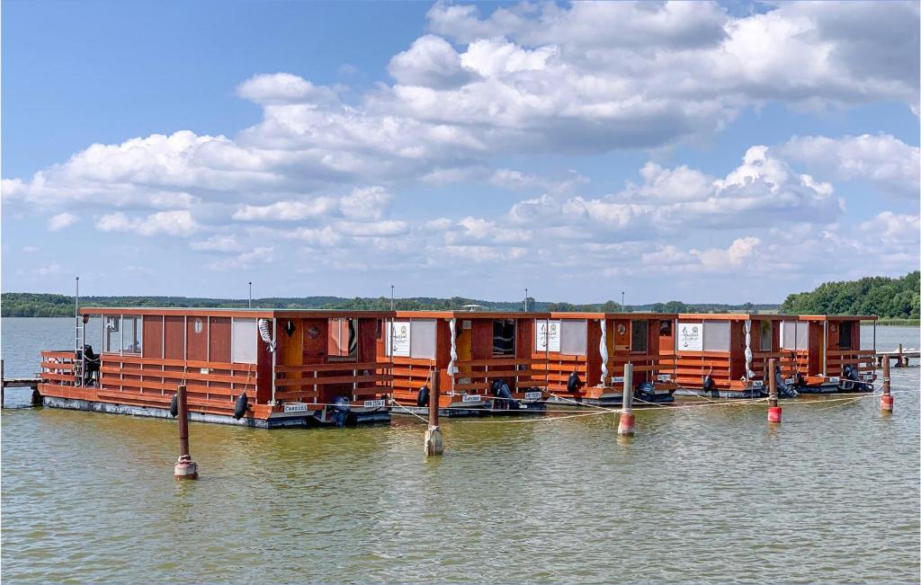 a row of houses on a boat in the water at Stunning Ship In Neuruppin With House Sea View in Neustrelitz