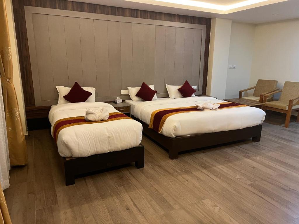 En eller flere senger på et rom på Hotel Murano