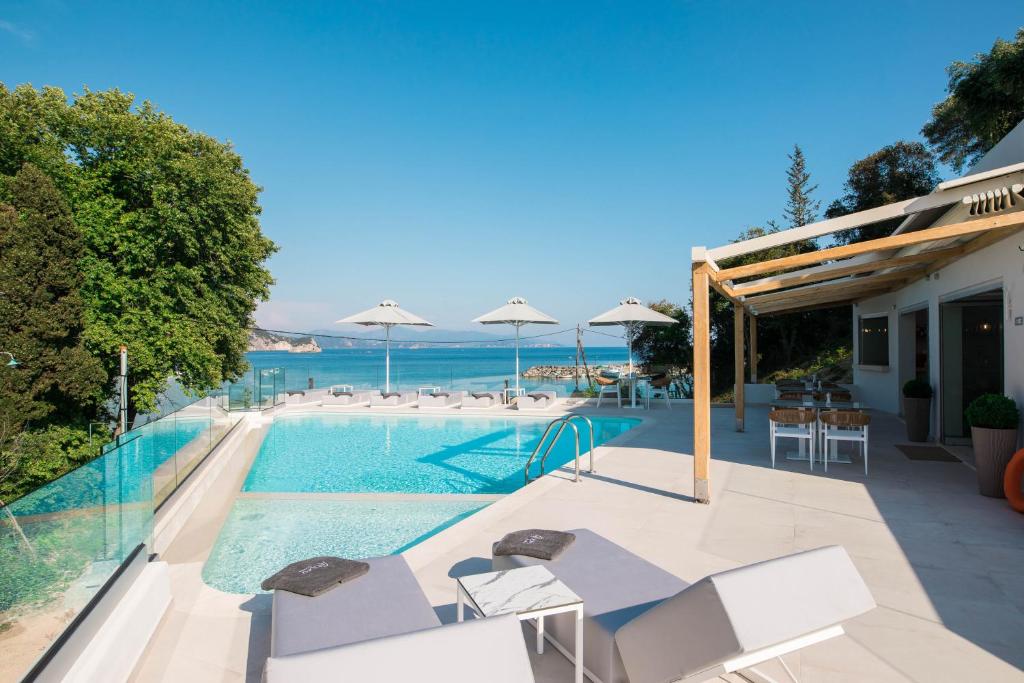 a swimming pool with a view of the ocean at Alboro seaside suites in Parga