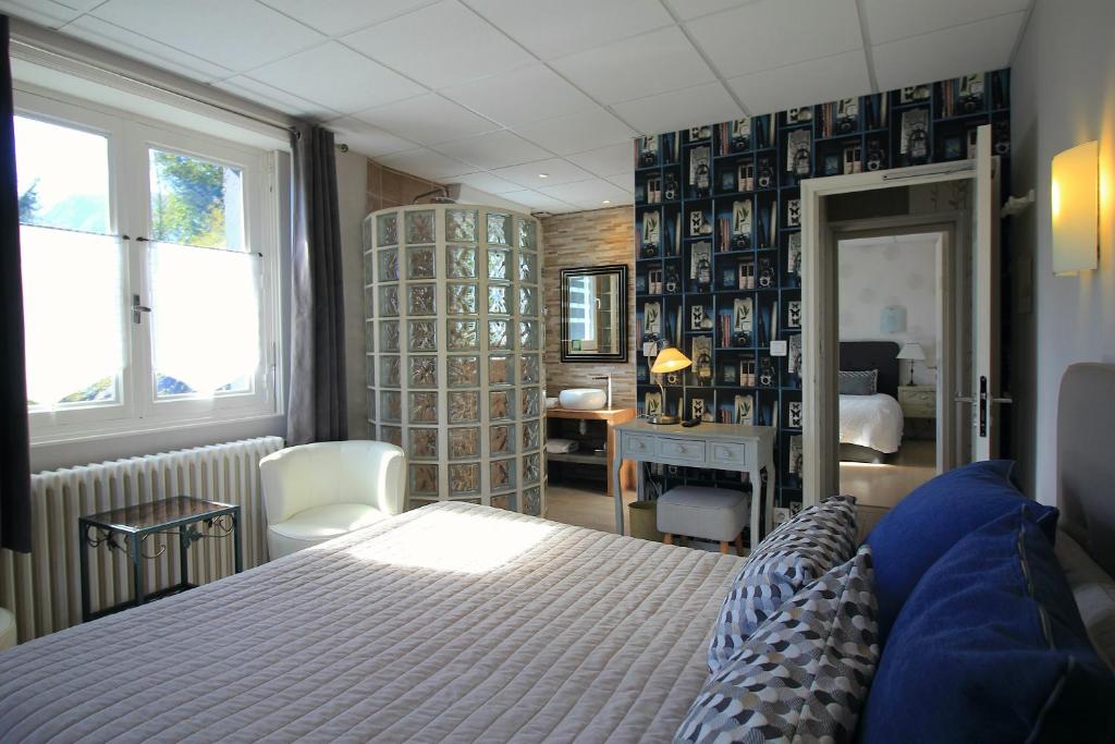 a bedroom with a bed and a desk in a room at Logis L'Ayguelade in Bielle