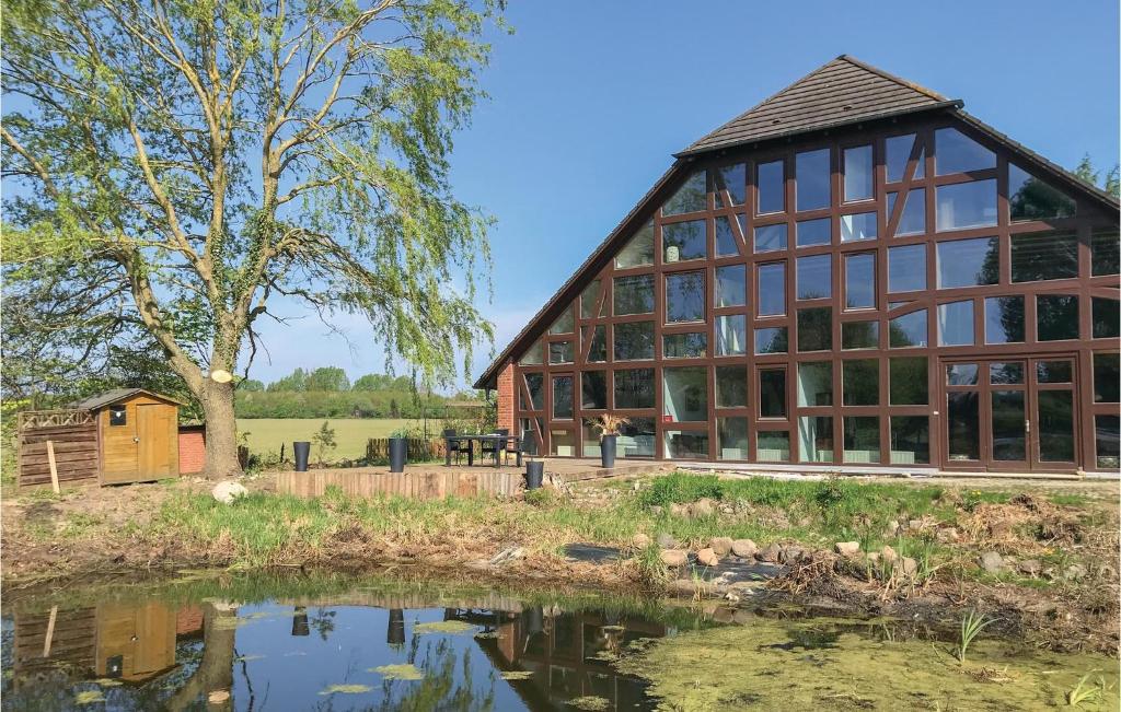 a large barn with a pond in front of it at Landhaus Dragun in Dragun