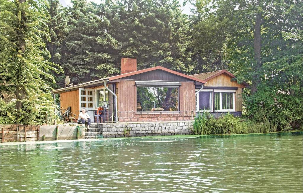 a house sitting on top of a body of water at Holiday Home Stromstrasse L in Manschnow