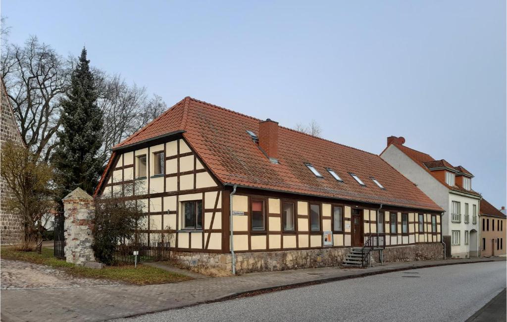 an old building with a red roof on a street at Awesome Home In Brssow With Kitchen in Brüssow