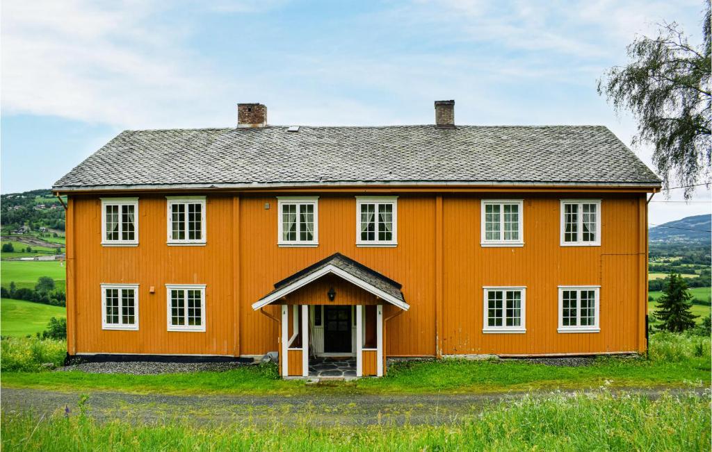 an orange house with a gray roof at Amazing Home In stre Gausdal With Kitchen in Svingvoll