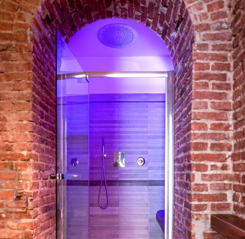 a bathroom with a shower with a purple lighting at Luxury Apartment in Milan Center in Milan