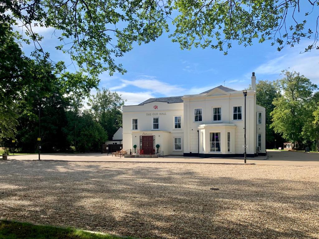 a large white building with a driveway in front of it at The Old Hall Hotel in Coventry