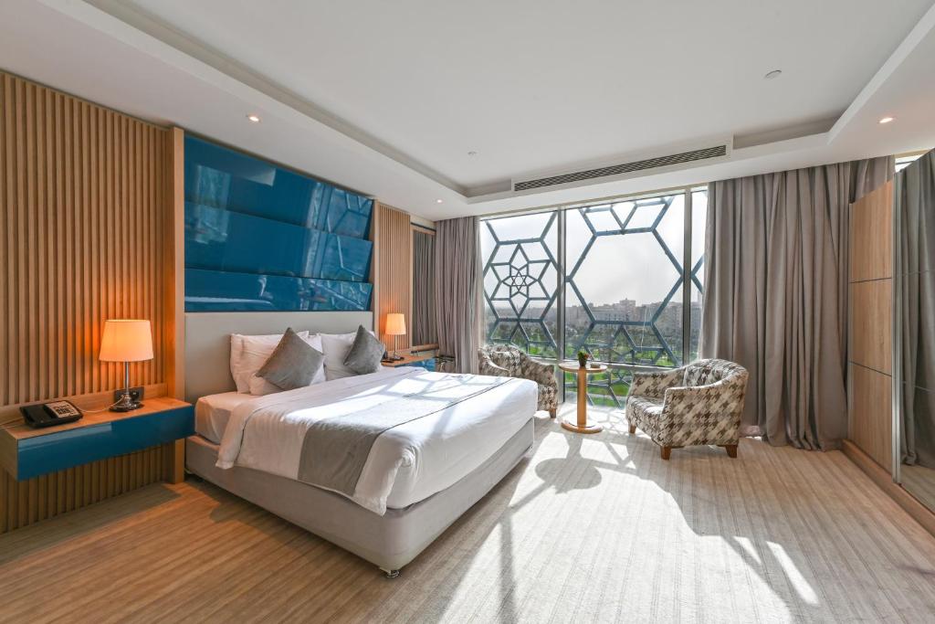 A bed or beds in a room at Al Mansour Suites Hotel