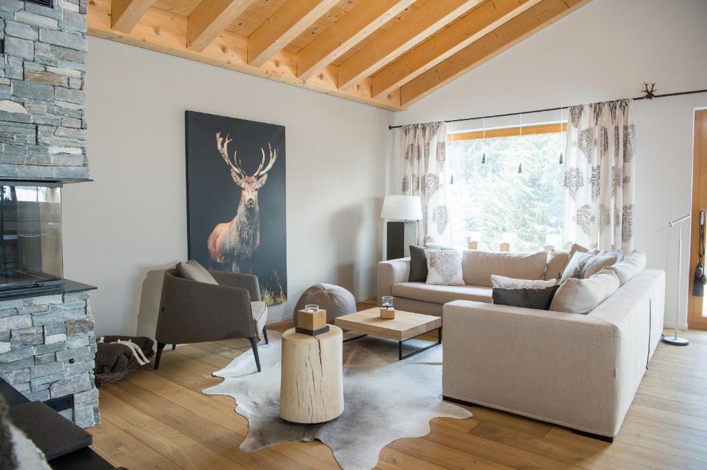 a living room with a couch and a fireplace at Central holiday flat Scalottas Lenzerheide in Lenzerheide