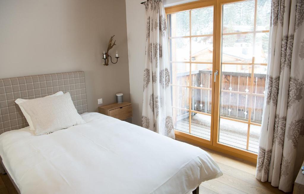 Postel nebo postele na pokoji v ubytování Central holiday flat Scalottas Lenzerheide