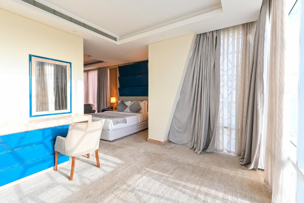 A bed or beds in a room at Al Mansour Suites Hotel