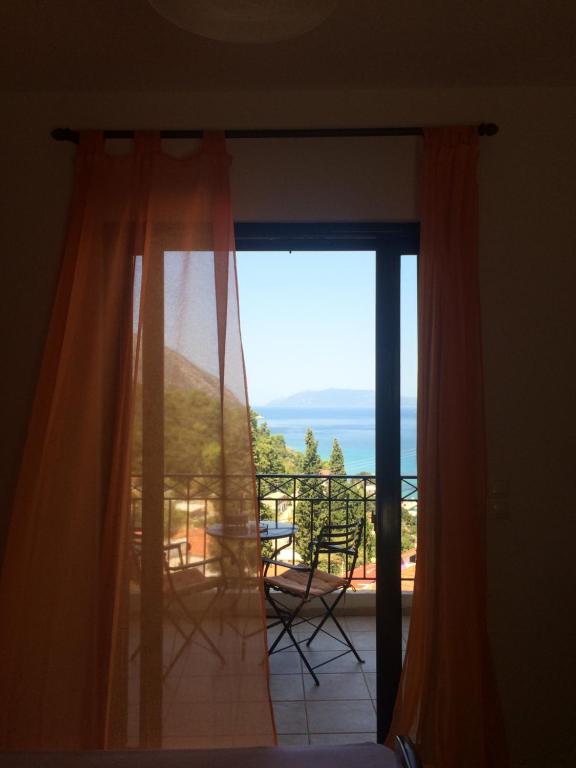 a room with a window with a view of the ocean at Giannatos' Studios - Makis in Poros