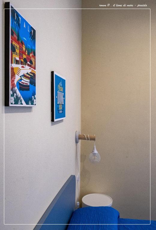 a bathroom with a toilet and a poster on the wall at Il Leone Di Mare in Procida