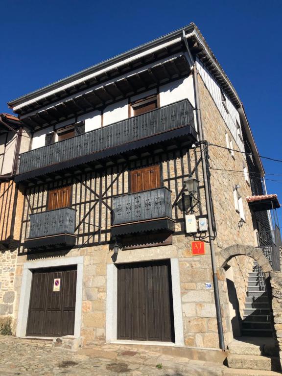 a building with wooden doors and balconies on it at El Palaero in La Alberca