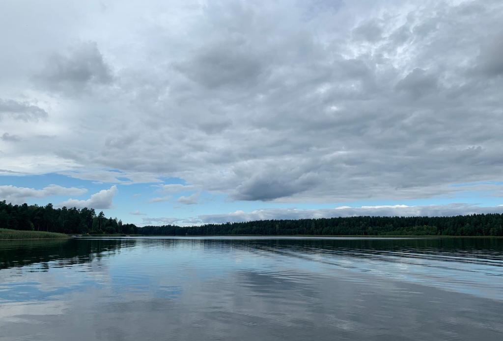 a large body of water under a cloudy sky at Lake apartment Zefir 15 in Augustów